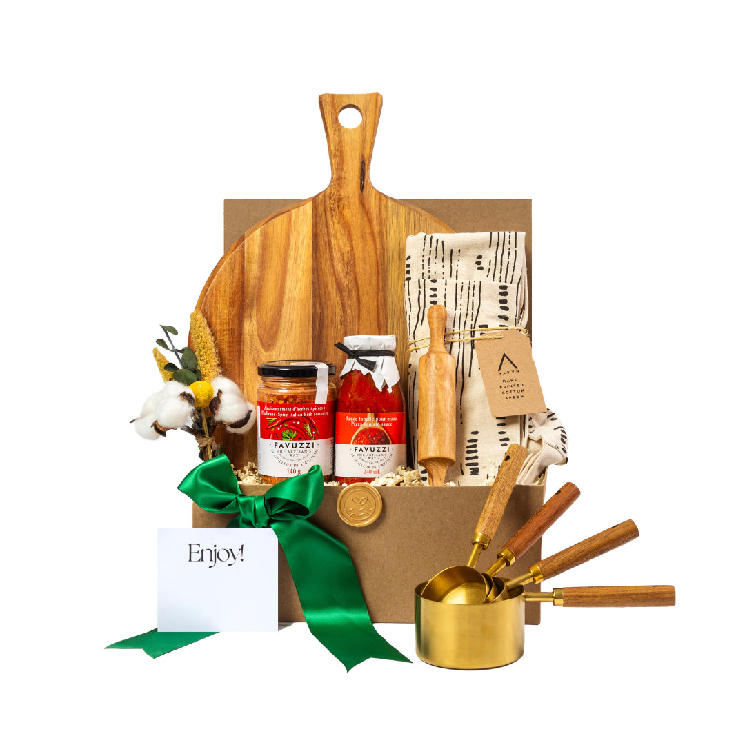 A pizza night themed gift basket with wooden cutting board, wooden rolling pin, gold stainless steel measuring cups with wooden handles, Favuzzi pizza sauce and Favuzzi Itallian herb mix