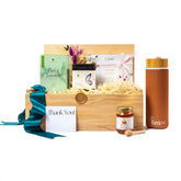 Luxury gift basket with cookies, honey, green tea, earl grey tea and a luxury tumbler in a wooden gift basket