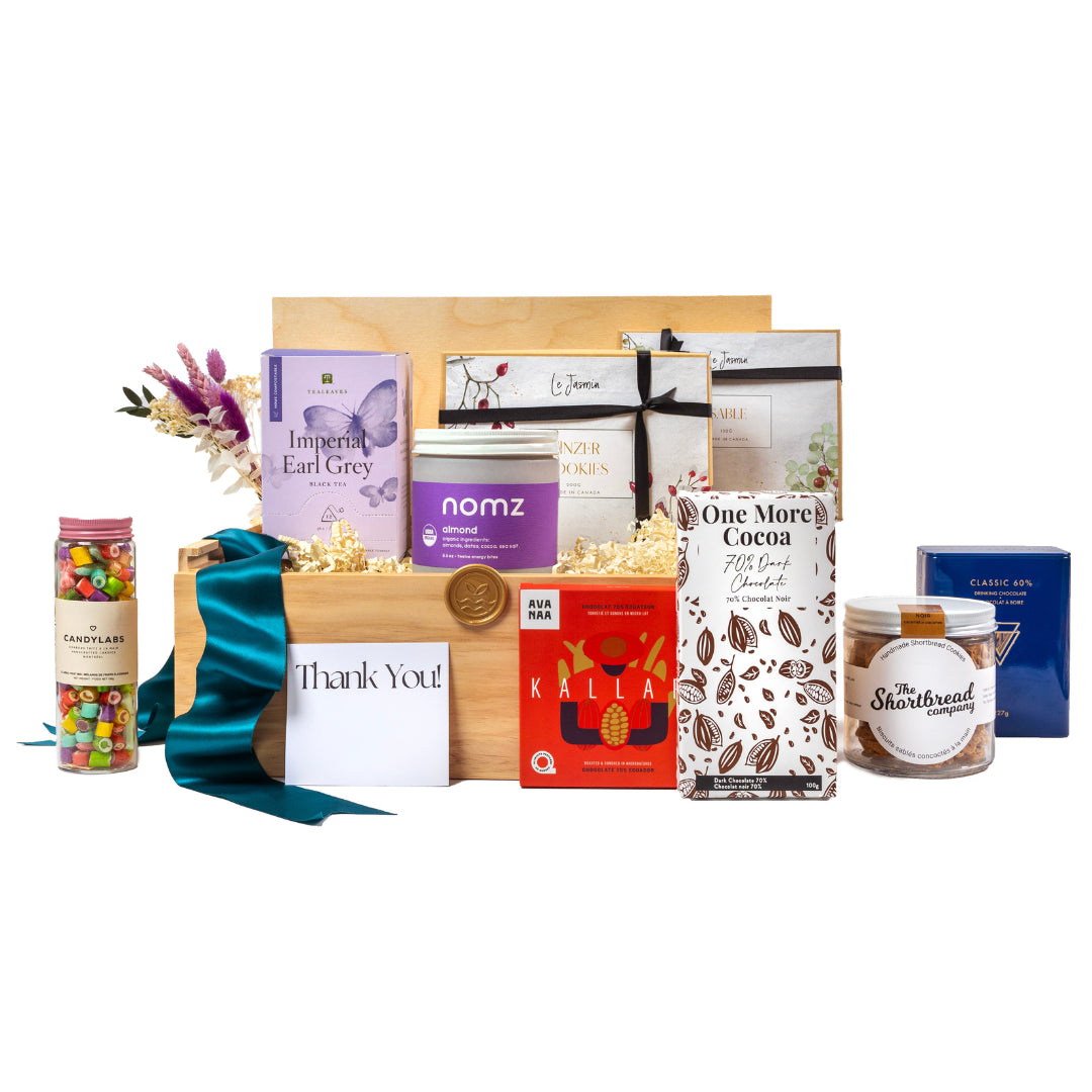 Luxury sustainable client gift basket with eco-friendly products including artisanal tea, cookies, chocolates, and a thank-you card. Plastic-free packaging with products sourced from local small businesses in Toronto. Perfect for corporate gifting and office sharing. Thoughtful, elegant, and environmentally conscious gift solution