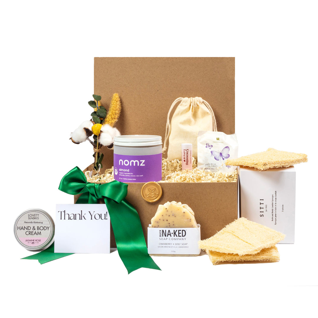 luxury sustainable gift basket with compostable tea bags, artisanal soap, small batch hand and body cream, nomz, and sitti body sponges all in a kraft gift box