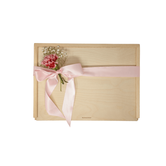 Wooden gift box decorated with a silk pink ribbon