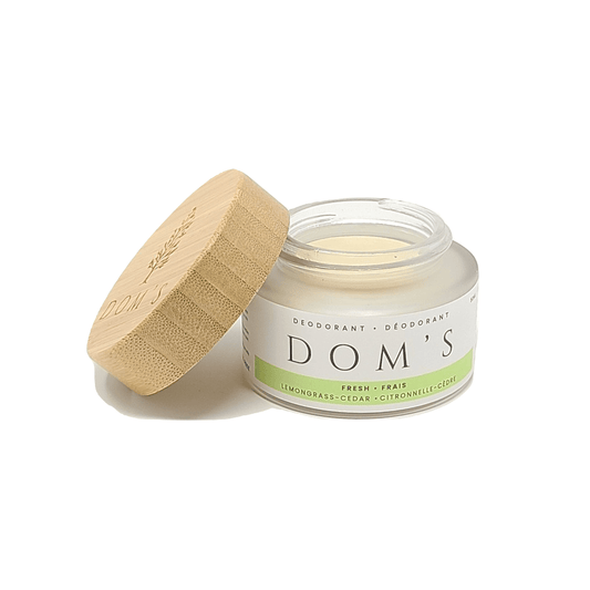 Doms natural deodorant in a plastic free packaging with an open lid next to it