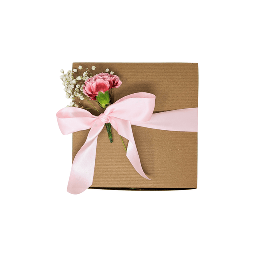 Plastic free gift box with pink satin ribbon and flowers as decoration